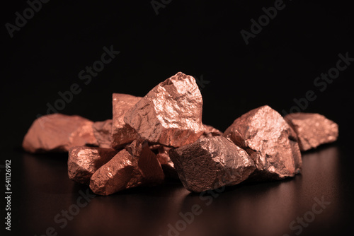 Ingots of pure copper or pink gold on a black background.