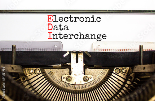 EDI electronic data interchange symbol. Concept words EDI electronic data interchange typed on old retro typewriter. White background. Business and EDI electronic data interchange concept. Copy space.