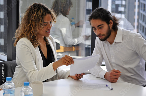 Business coaching session with two pacific islanders in office