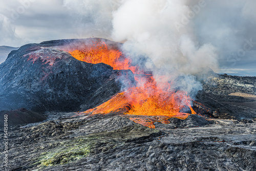 leveling off eruption from a volcanic crater. active volcano in the landscape in Geopark of Reykjanes Peninsula. glowing hot lava flows from the volcano with strong steam