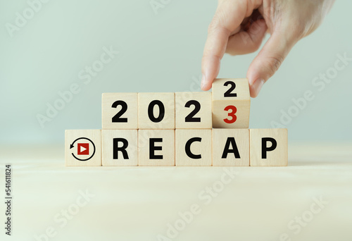 2022 Recap economy, business, financial concept. Business plan in 2023. RECAP words, 2022 and 2023 on wooden cubes on smart grey background and copy space.
