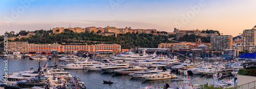 Monte Carlo cityscape and luxury yachts in harbor of Monaco, Cote at sunset
