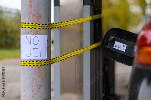 A pump at a gas station without fuel and a no fuel sign, due to a shortage of fuel truck drivers.