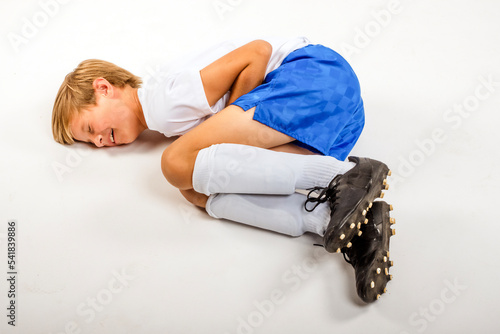 Youth Child Boy Soccer Player Laying on Ground in Studio