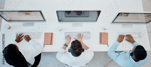 Top view, call center and consulting doing customer service, headset and computers doing typing in office. Business, coworkers and consultant workers doing client support, telemarketing and speak.