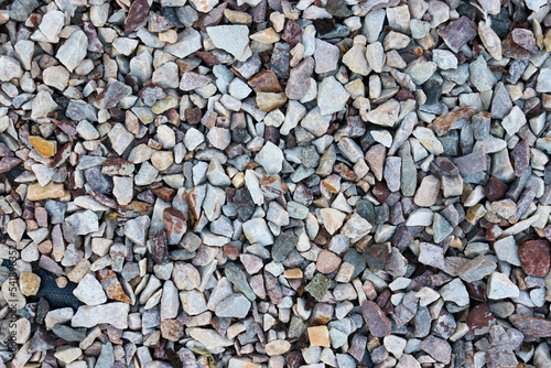 small stone background, light gravel road pebbles stone texture. Abstract background with farden pebbles. Gravel surface