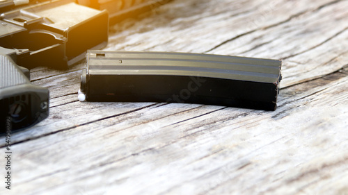 Close up magazine of air soft gun or bb gun on wooden floor, soft and selective focus on the magazine