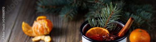 banner of Traditional tasty mulled wine hot drink with mandarin apple spices and christmas tree in white cup