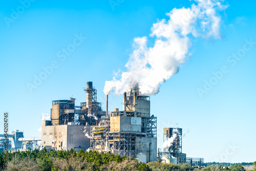 Industrial paper mill factory plant with chimney smokestacks stacks emitting carbon dioxide emission pollution in Georgetown, South Carolina town
