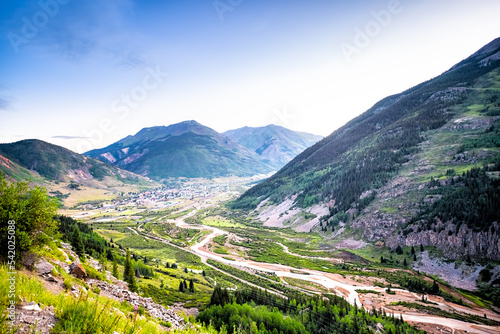 Wide high angle aerial view of Silverton, Colorado small town from overlook at morning sunrise in summer with Mineral creek river, Rocky mountains