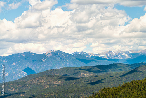 Carson National Forest by Sangre de Cristo mountains with green pine trees in summer and peak overlook from route 76 high road to Taos, New Mexico
