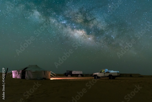 Night sky milky way over camel farm camp in the desert of empty quarter.