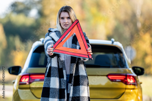 A woman waiting for roadside assistance.