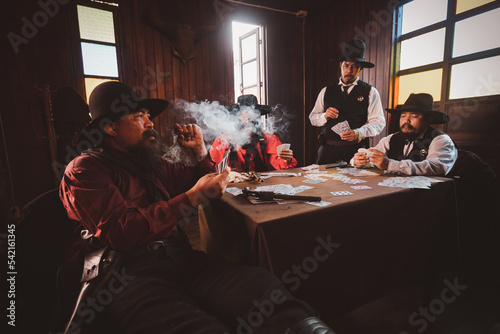 Cowboys group playing poker and card gambler game in old American west saloon is cowboy vintage life style.