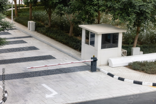 car park barrier, automatic entry Security system for building access - gate stop with toll booth, traffic cones and cctv.The checkpoint with a gate