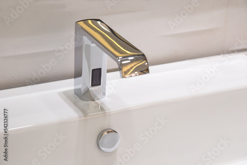 Bathroom faucet in polished chrome powered automatic by sensor. object about home Improvement.