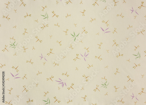 Close up on a high detailed photograph of a Japanese furoshiki cloth with a pattern design illustrated by odonata dragonflies and damselflies insects and broad-leaf bamboo or sasa bamboo leaves.