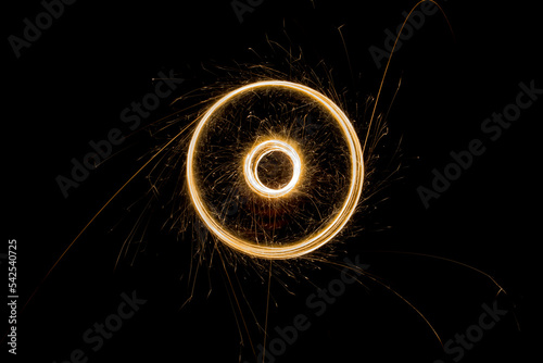 Sparks from the circular rotation of lights on a black background