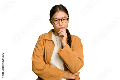 Young Asian woman isolated suspicious, uncertain, examining you.