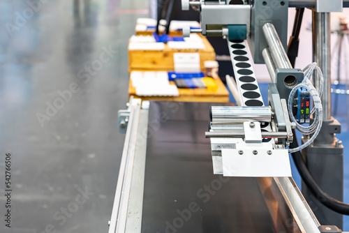 automatic continuous labeling machine for labelling product on belt conveyor in manufacturing process in industrial