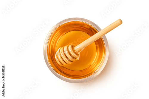 Glass bowl of honey with honey dipping on white background. Top view 