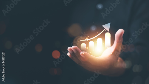 Businessman showing business growth and success graph ,concept of progress in development, financial efficiency and investment with business strategy for goals and opportunities in the industry future