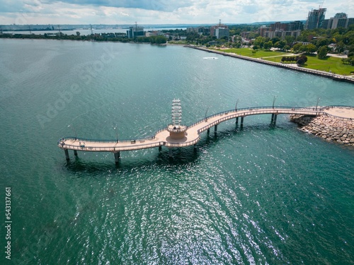 Brant Street Pier on the rocky shore of Lake Ontario with the cityscape in the distance