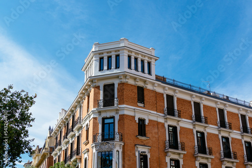 Old luxury residential building with brick facade in Chamberi district in central Madrid