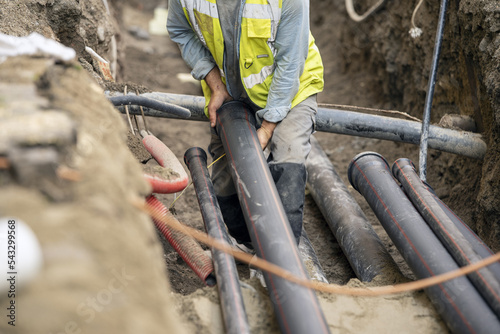 Workers install underground pipes for water, sewerage, electricity and fiber optics for the population of an urban center.