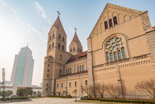QINGDAO, SHANDONG PROVINCE, CHINA: St. Michael's Cathedral, architectural contrast with massive glass and concrete high rise