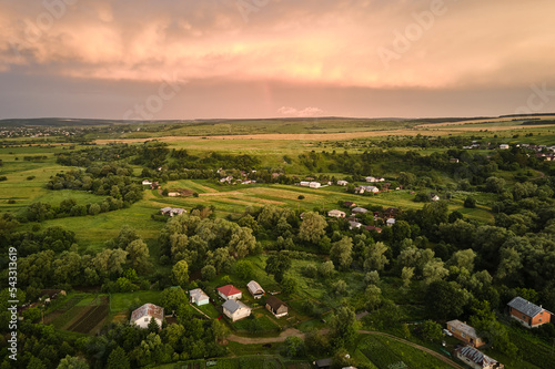 Aerial view of residential houses in suburban rural area at sunset