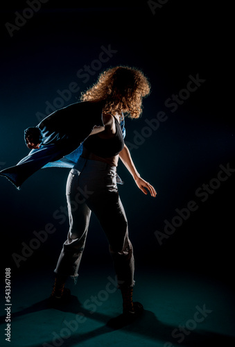 Contemporary style dancer on dark wall