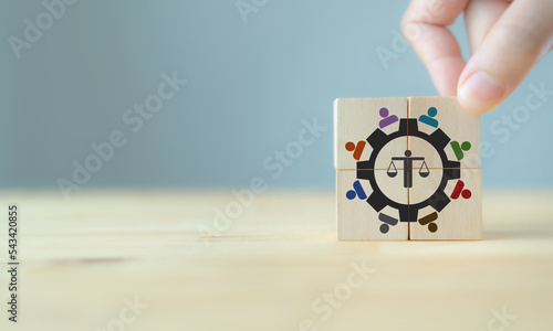 Business ethics concept. Ethical corporate culture. Ethical investment, sustianable development. Business integrity and moral. Putting wooden cubes with ethics mindset and teamwork icons.