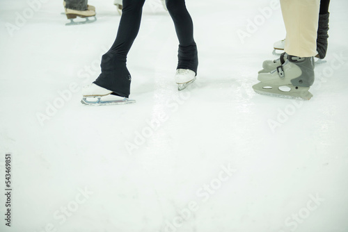Close up of legs in skates on skating rink. Winter sport.