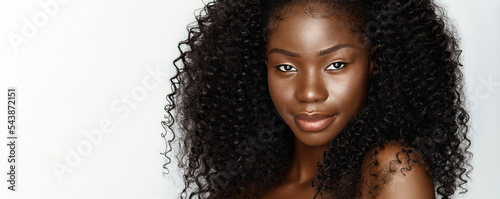 Curly afro hair. Wig. Fashion portrait of young beautiful african american woman with curly hair against gray background