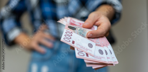 Serbian 1000 dinars banknotes cash in hand.