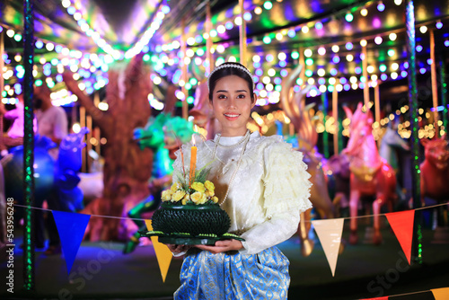 Portrait Beautiful Young Asia woman with Traditional Thai costume hold Banana leaf cockerel or Kra Thong in Thai , Loy Krathong Festival on November