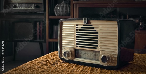 old tube radio on tablecloth vintage stuff background