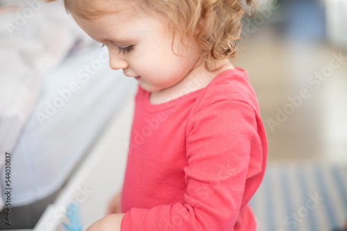 toddler girl looks down 