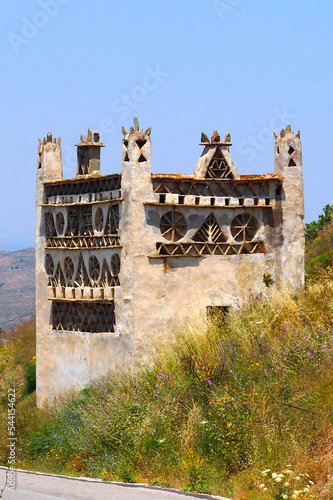 In the Cyclades, in the heart of the Aegean Sea, Tinos is an island with many dovecotes scattered throughout its varied landscape. These dovecotes are very characteristic of the local architecture