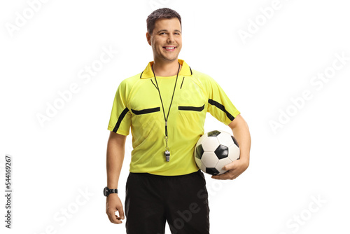 Football referee holding a ball and smiling at camera