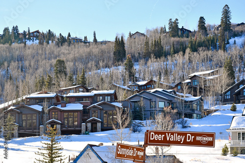 Vacation homes on a snowy tree lined hillside in the Park City and Deer Valley ski areas during winter in the Wasatch Mountains near Salt Lake City, Utah