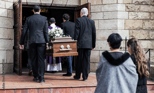Death, funeral and people with coffin to church, chapel service and ceremony for temple ritual. RIP, mourning and burial of dead in casket, respect or christian religion, memorial and grieving family
