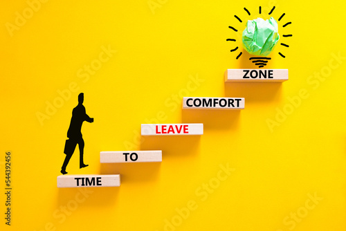 Leave comfort zone symbol. Concept words Time to leave comfort zone on wooden blocks. Businessman icon. Beautiful yellow background. Business time to leave comfort zone concept. Copy space.