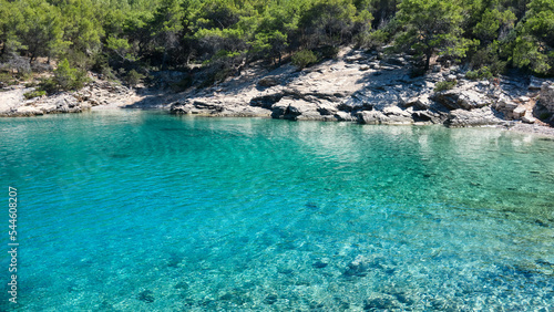 Hvar island coastline in Summer. Maslinica Beach, Public bathing wild pebble beach near Vrboska village. Wild pine forest on coast of Adriatic Sea. Hvar island, Dalmatia, Croatia.