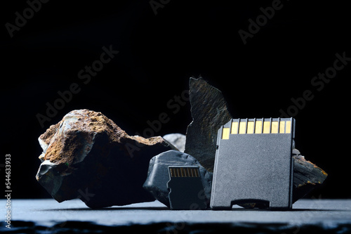 Composition of micro sd cards and dark stones. close-up