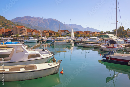 Beautiful autumn Mediterranean landscape. Fishing boats in harbor. Montenegro, view of Tivat city and Marina Kalimanj