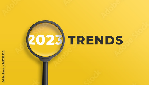 Magnifying glass magnifies 2023 trends on yellow background. Focusing on the year 2023 for technology trends update concept. 3D illustration.