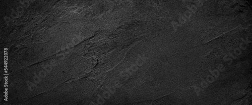 Black or dark gray rough grainy sand texture background