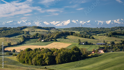 Countryside landscape in the Gers department in France with the Pyrenees mountains in the background